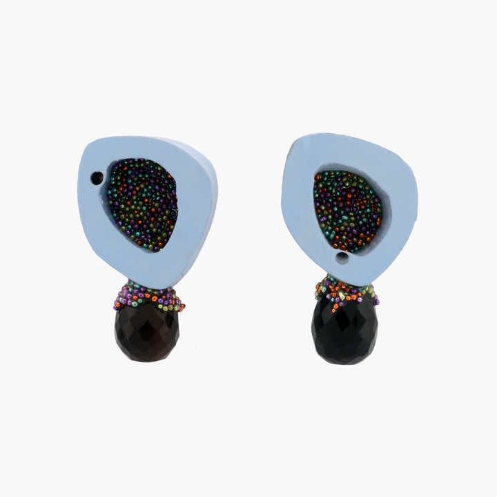Playful and bright stud earrings, created from painted ovine bone in milky blue and onyx. The earrings are backed with sterling silver and have sterling silver posts.   1.7 x 2.8 x 0.8 cm, 2023
