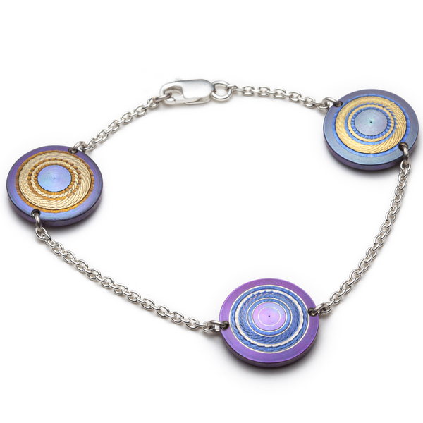 Chroma Titanium Bracelet in a soft play of violets, purples and gold on a sterling silver chain. 16mm discs, 7"/18 cm length.