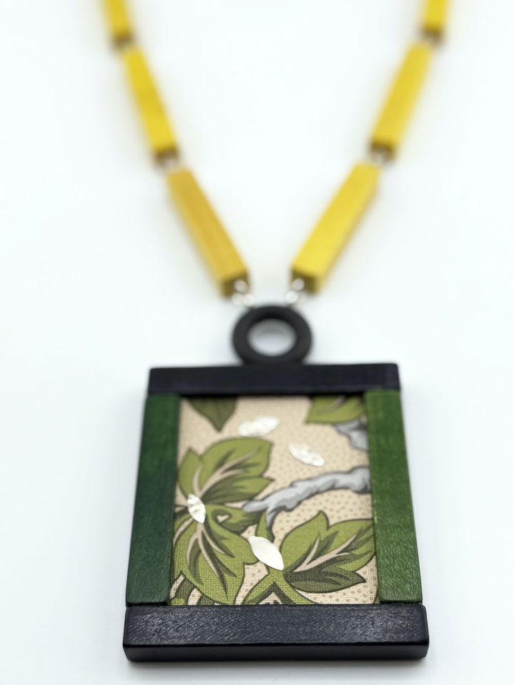 Necklace with a square pendant featuring a nature design 