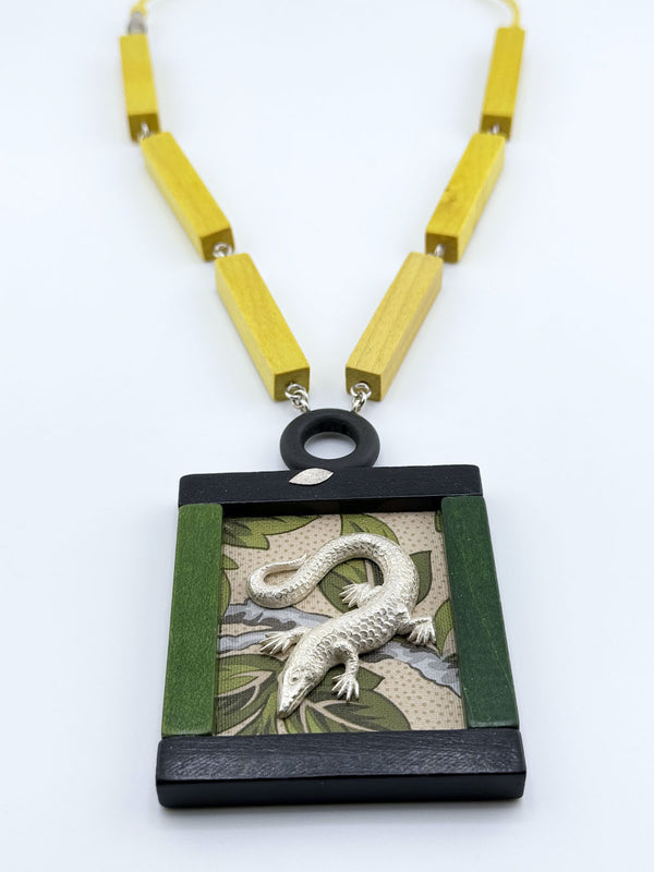 Necklace with a pendant featuring a lizard design