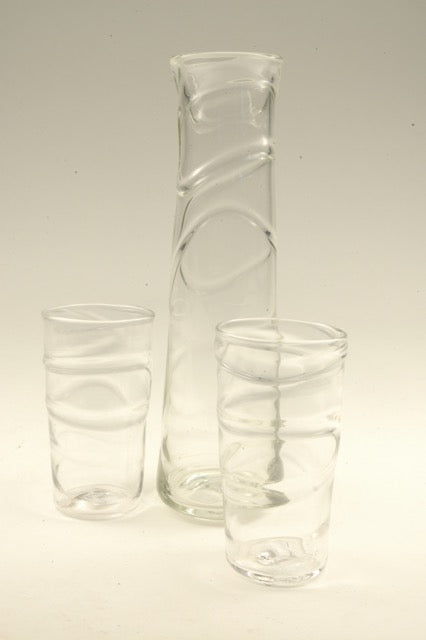 Oxbow decanters/vases refer to the winding paths of rivers. These hand blown glass vessels and the matching tumblers can be used equally as small vases for home or office and make wonderful sets with the matching tumblers or the small xylem cups. 
Available colours are pink, salmon, gold, sea green, blue, and red. Please contact us for additional information and photos of other colours.
Each piece sold individually: oxbow Decanter, $108; oxbow tall glass $48 each. 
