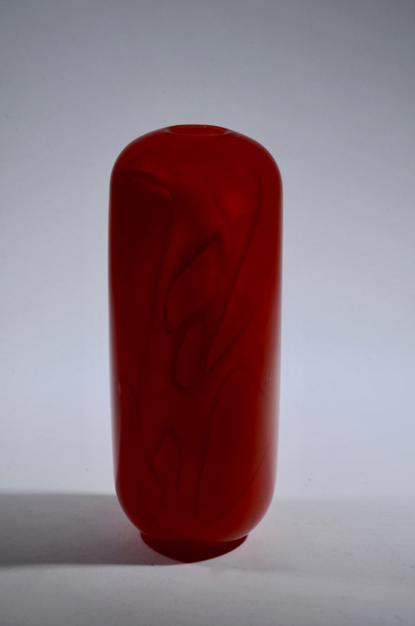 Shadow Vase Series: tall red glass vessel with shards captured within the layers of the glass and a sandblasted surface, 3.5" x 5". 