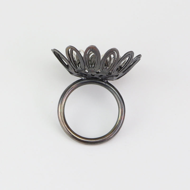 Dahlia Ring  Floral ring of sterling silver and silver with an oxide patina. The petals radiate with lively energy from the play of the negative space with the two colours.  3x3x3cm