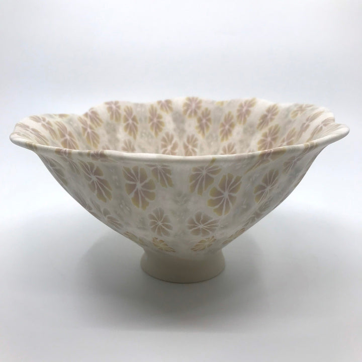 Multicolour ceramic floral bowl in orange and brown, with rippled sides, made with the nerikomi ceramic technique.