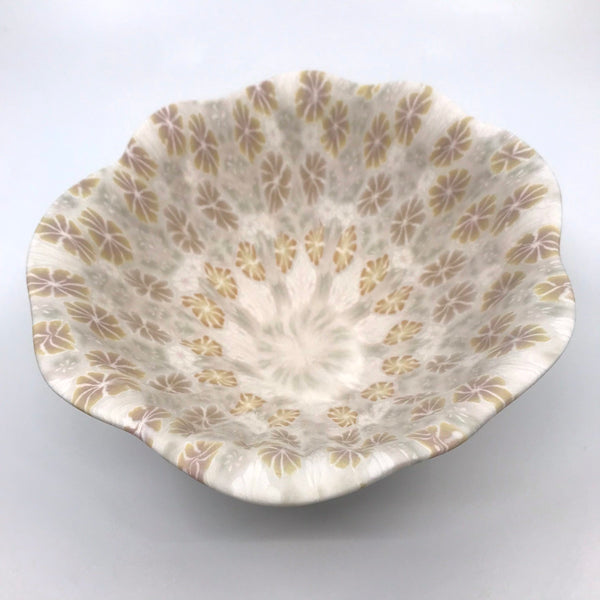 Multicolour ceramic floral bowl in orange and brown, with rippled sides, made with the nerikomi ceramic technique.