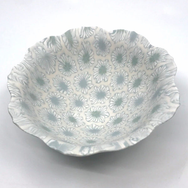Small multicolour ceramic floral bowl in blue and green with a delicate scalloped edge, made with the nerikomi ceramic technique.