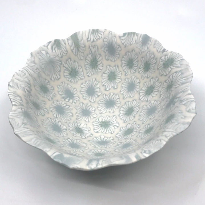 Small multicolour ceramic floral bowl in blue and green with a delicate scalloped edge, made with the nerikomi ceramic technique.