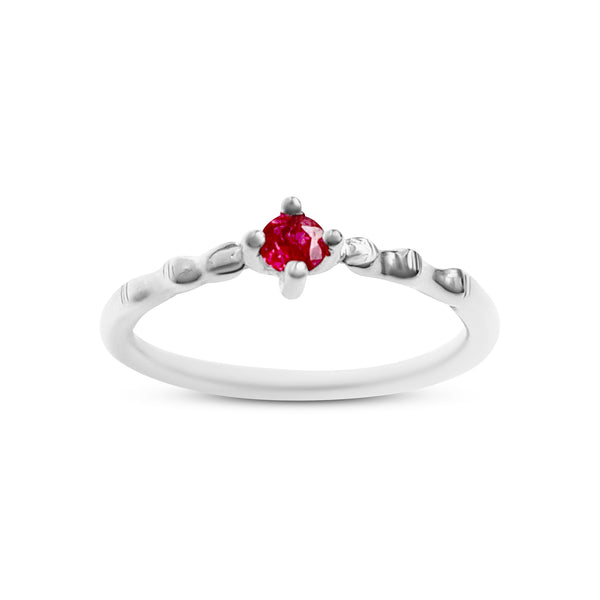 Silver ring with a red gemstone on a white background