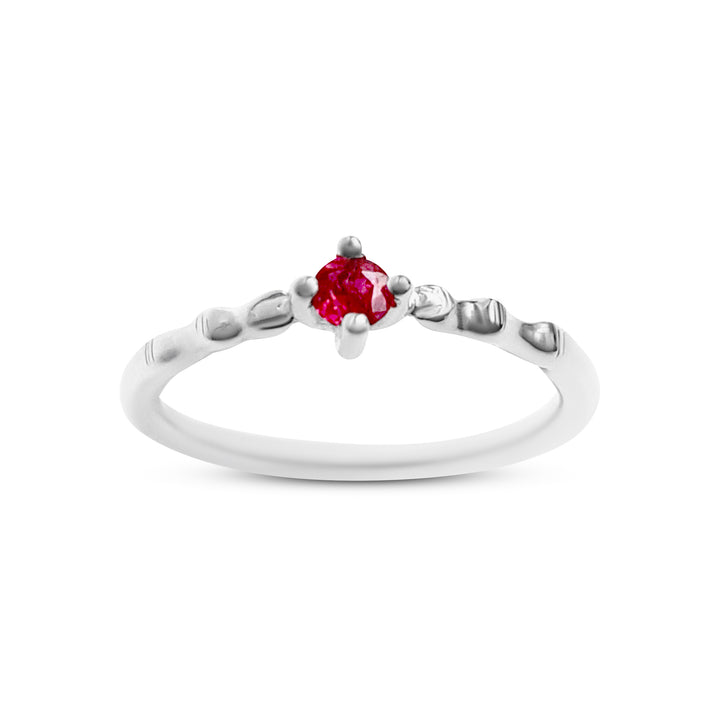 Silver ring with a red gemstone on a white background