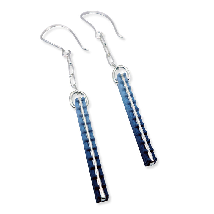 Pair of blue and silver earrings on a white background