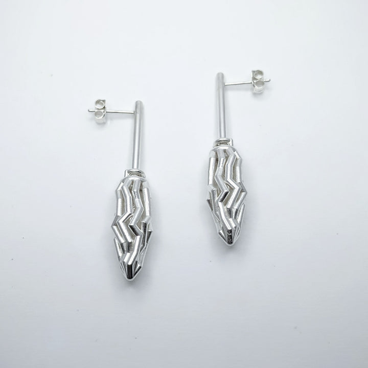 Earrings No. 46712370, from the Seed Collection. 2023.   Created with algorithmic design and 3D printing, these earrings are made of sterling silver.  6x2x1.5cm each
