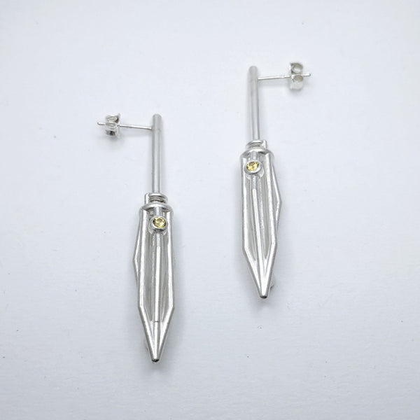 Earrings No. 95049640, from the Seed Collection. 2023.   Created with algorithmic design, 3D printing, and stone setting, these earrings are made of sterling silver and yellow sapphires.  6x2x1.5cm each