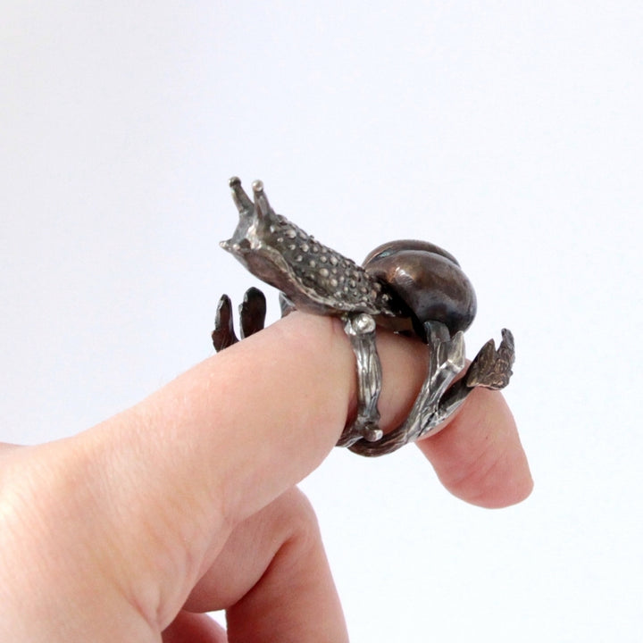 snail ring on finger