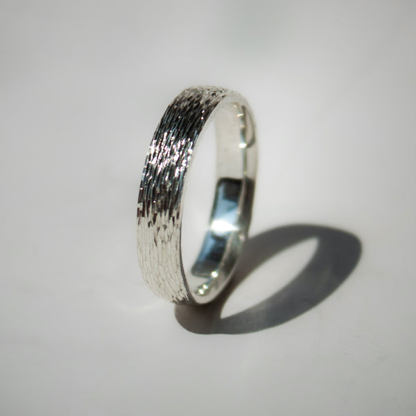 Silver ring with textured band