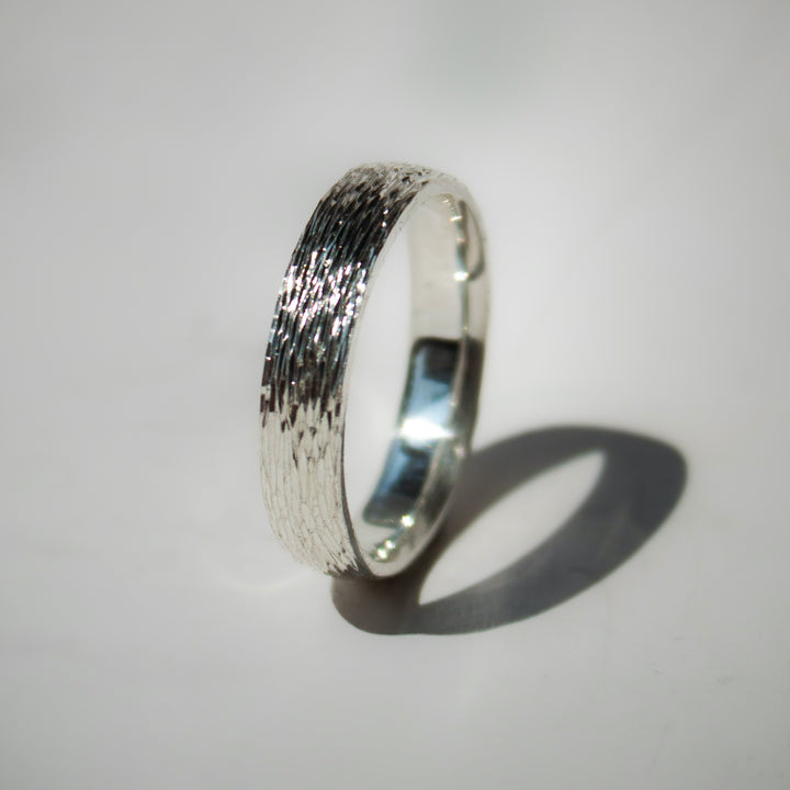 Silver ring with textured band