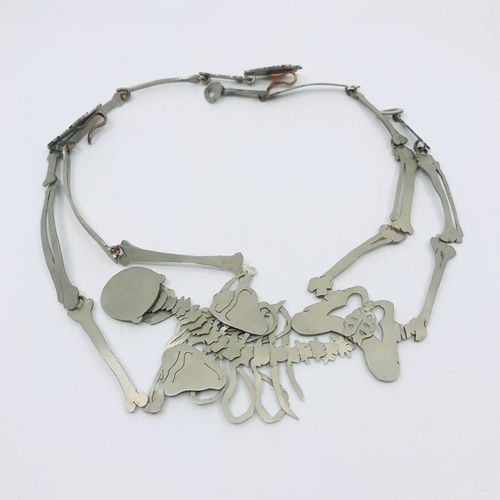 Necklace with skeletal design on a white background