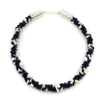 Indigo 2 necklace, 2023. Deep blue Swarovski crystals and mother of pearl are braided into an elegant form using traditional Japanese kumihimo braiding. The clasp is made from woven sterling silver.