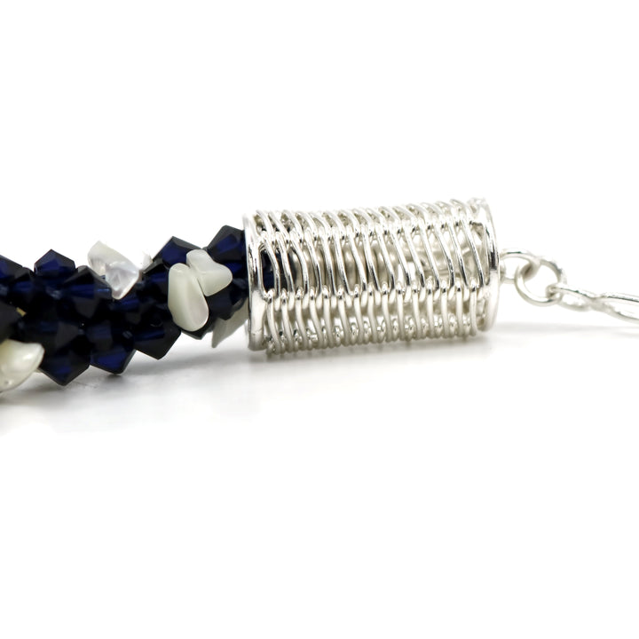 Indigo 2 necklace, 2023. Deep blue Swarovski crystals and mother of pearl are braided into an elegant form using traditional Japanese kumihimo braiding. The clasp is made from woven sterling silver.