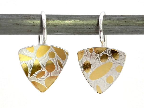These Trillion earrings are comprised of silver and 24 karat gold which has been diffusion bonded and formed, resulting in an exciting interplay between two fine metals. Available in stud or dangle styles.