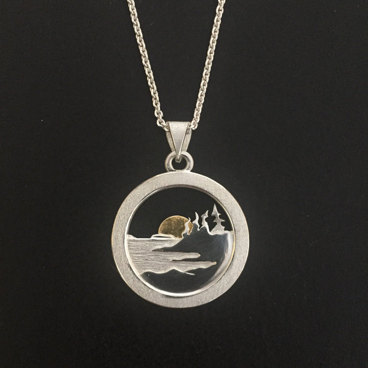 Shoreline pendant in sterling silver with a 24k gold sun.  Pendant is  3 mm diameter