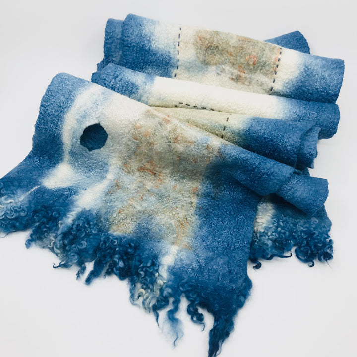 Blue scarf with stitched rectangles, created with hand-dyed silk and merino wool with recycled materials.