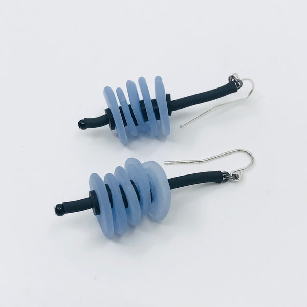 Earrings of flat glass beads with black rubber cord, from the Stack series. 