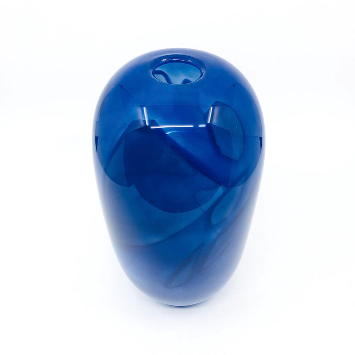 Shadow Vase Series: tall blue glass vessel with shards captured within the layers of the glass, 9.5" x 4.75". 