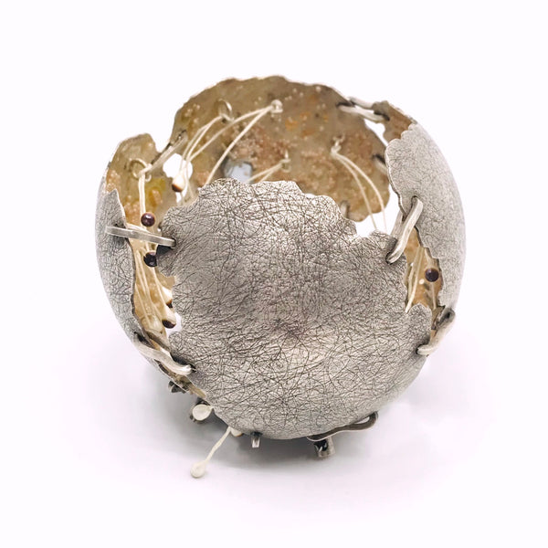 Phase Iteratives: Phase 3 Vie Fictive.  Sterling silver brooch with rust, mirror, freshwater pearls, glass microbeads and gold leaf in the interior.