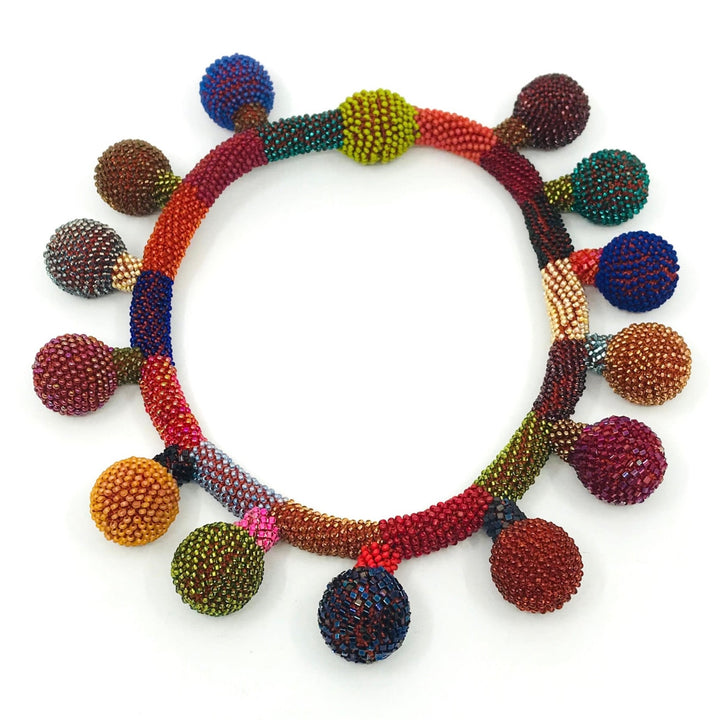 Balloon Necklace. Multicoloured glass beads are woven together with red-orange thread. 46cm long (18"), with a strong magnetic clasp.