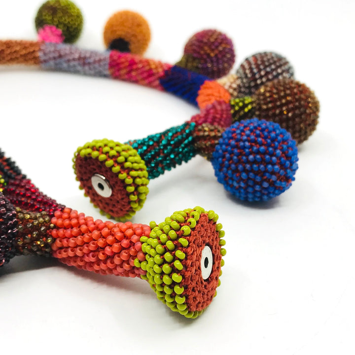 Balloon Necklace. Multicoloured glass beads are woven together with red-orange thread. 46cm long (18"), with a strong magnetic clasp.