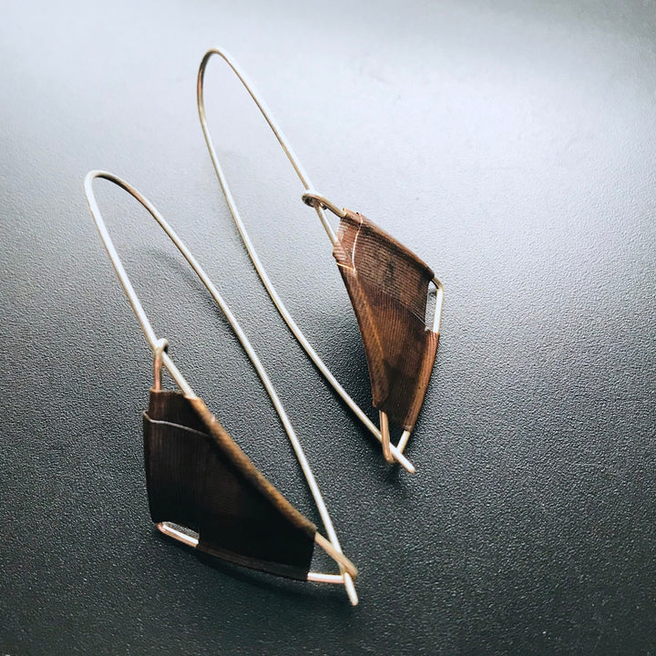 Long Sail earrings in brown brass and sterling silver.
