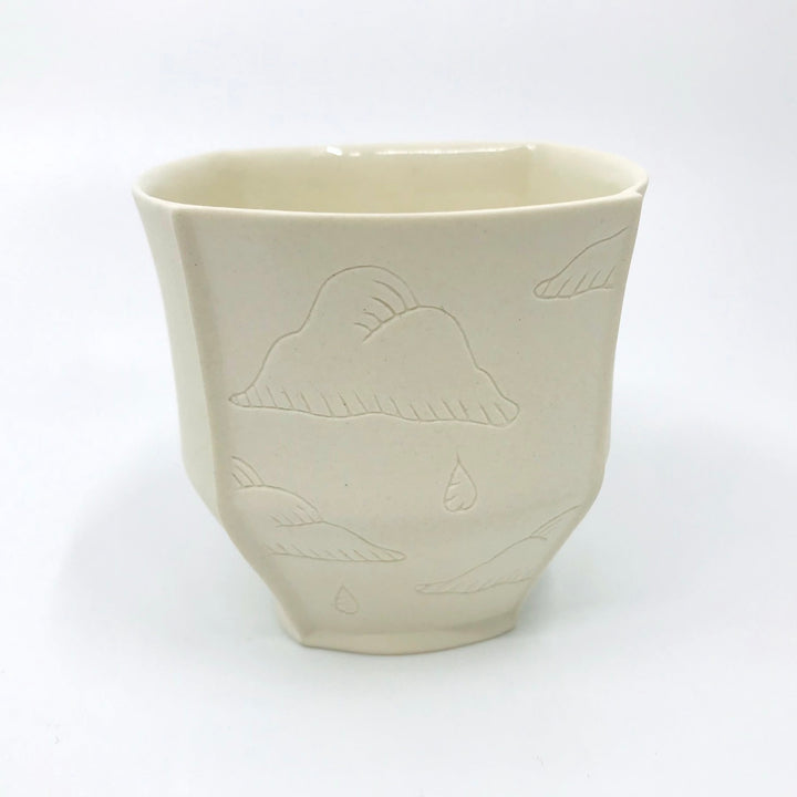 Small slip-cast porcelain&nbsp;cup, with illustrated details etched onto two of the four exterior sides
