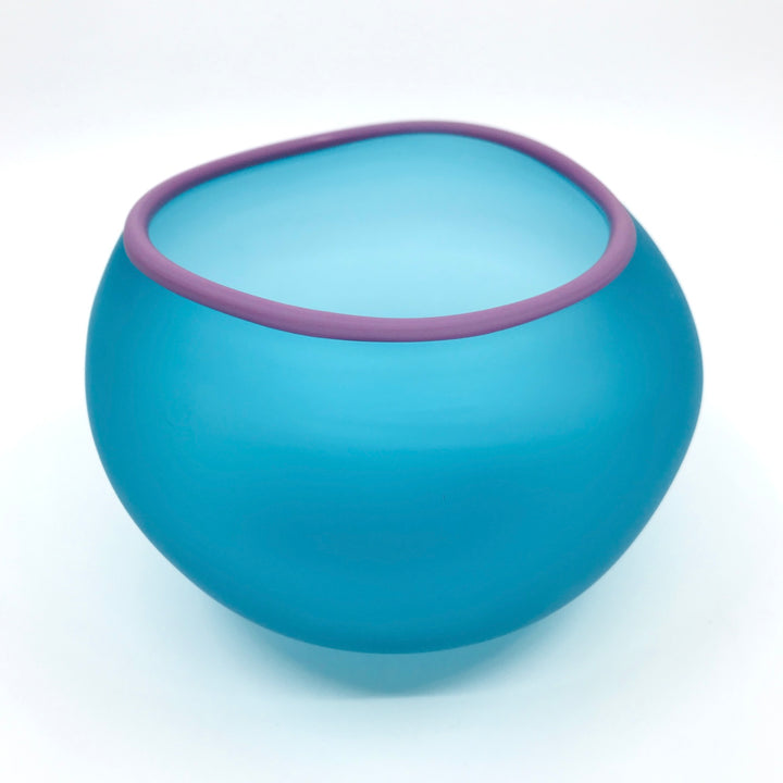 Supernatural bowl in aqua blue, with lavender purple rim. 18 x 16 x 11.5 cm.