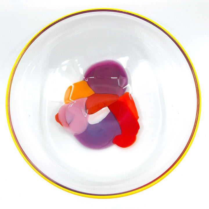 Storm Bowl of hand blown glass. One of a kind bowl in warm tones of purple, red, and orange. 25.5 x 25.5 x 9 cm.