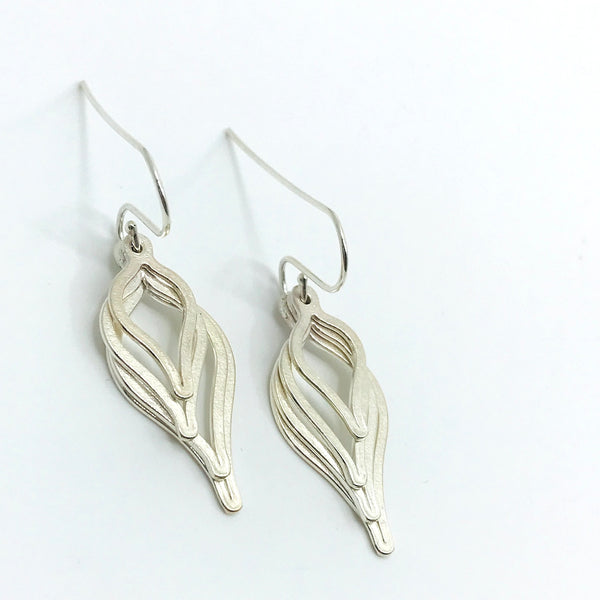 Sterling silver earrings featuring four stacked leaf forms in decreasing sizes. 
