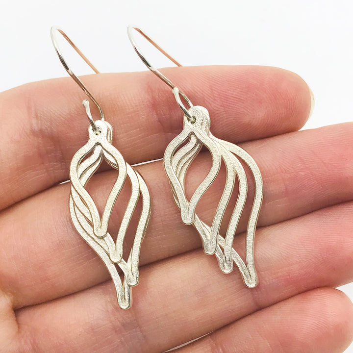 Sterling silver earrings featuring four stacked leaf forms in decreasing sizes. 