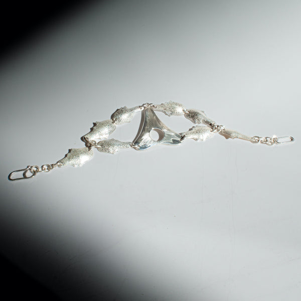 Silver bracelet on a gradient gray background