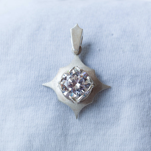 Silver pendant with a clear stone 