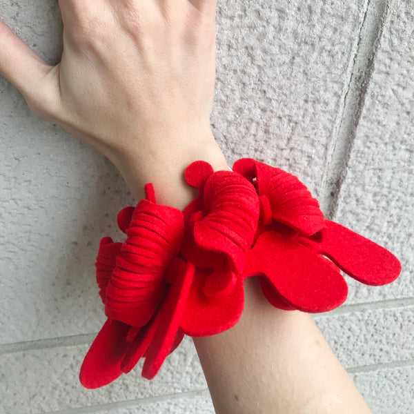 <em>D17 BRACELET - RED.</em> Bracelet of 100% wool felt created from interlocking forms, which join to create a piece which is both excitingly bold and easy to wear.