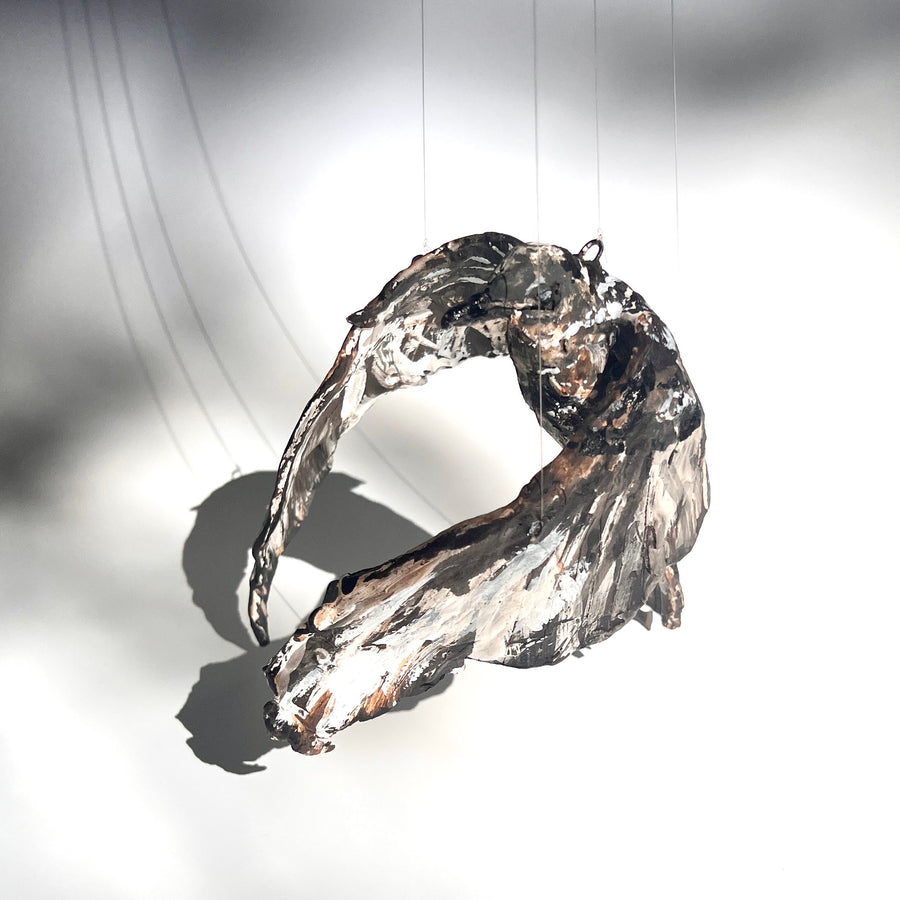 Parasitic Jaeger in Flight - wings cupped : multi-fired porcelain suspended sculpture of a jaeger in flight, its wings curved downwards. The surface is richly decorated with texture.