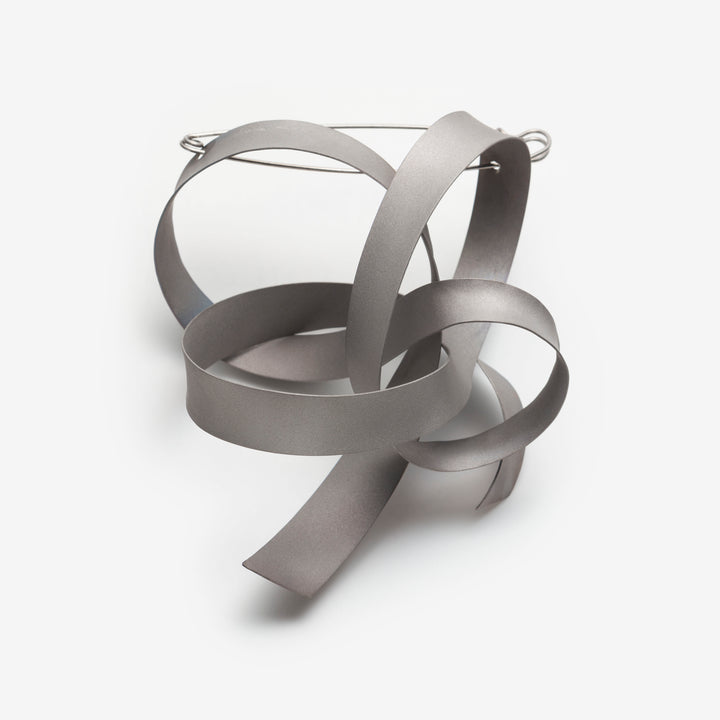Ribbon (L.1) in matte grey sandblasted titanium. 100mm X 140mm