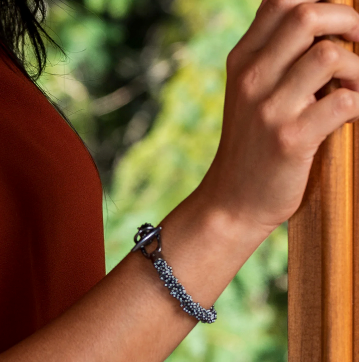 The oxidized silver ShikShok bracelet has a beautiful heft to it. The oxidation brings out gray-petroleum blue reflections in the metal. 7.5" or 20 cm long, and with a specially designed magnetic clasp for extra safety.