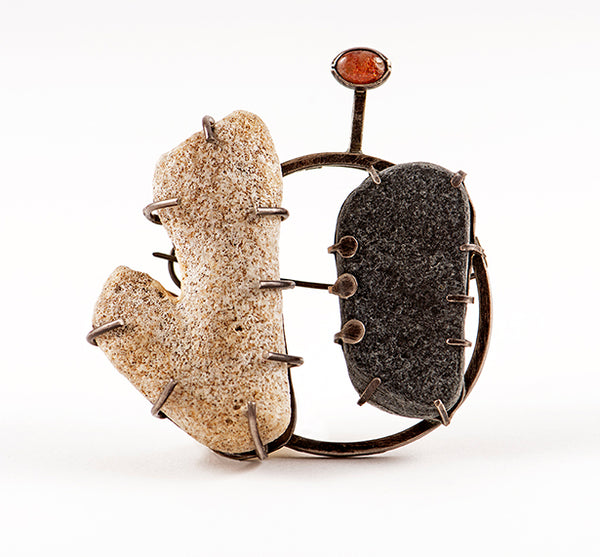 Brooch with two textured stones and a small round stone 