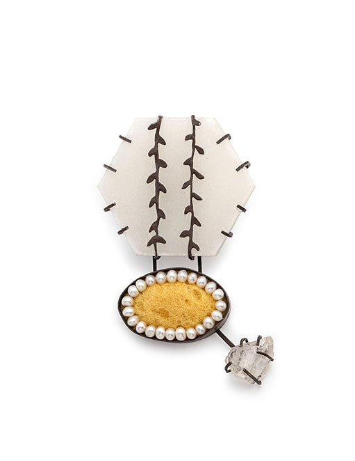brooch with pearl and gemstone details on a white background