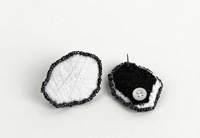 Black and white embroidered earrings