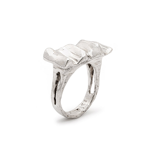 Silver ring with a textured band on a white background