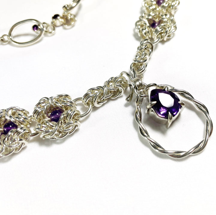 Murky Warrior (玄武), 2023.  This hand fabricated set with pauldrons--which can be separated into a neckpiece,  brooches, and earrings--is made from sterling silver, amethyst, amethyst beads, and acrylic. Every part is detachable and can be worn separately.