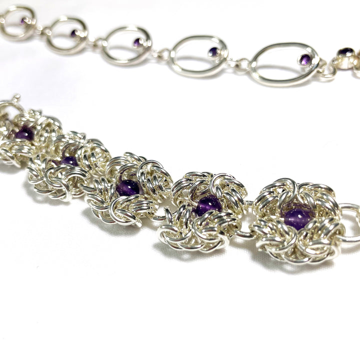 Murky Warrior (玄武), 2023.  This hand fabricated set with pauldrons--which can be separated into a neckpiece,  brooches, and earrings--is made from sterling silver, amethyst, amethyst beads, and acrylic. Every part is detachable and can be worn separately.