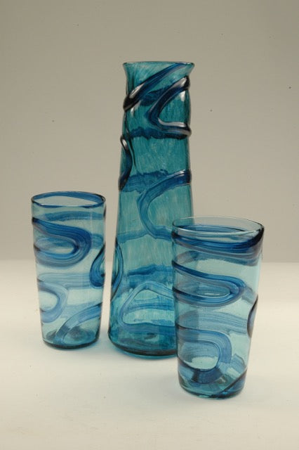 Oxbow decanters/vases refer to the winding paths of rivers. These hand blown glass vessels and the matching tumblers can be used equally as small vases for home or office and make wonderful sets with the matching tumblers or the small xylem cups. 
