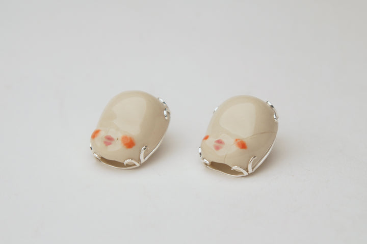 Baby Heads, 2023.  These hand fabricated stud earrings are made of ceramic, underglaze and clear glaze, china paint, and recycled silver.
